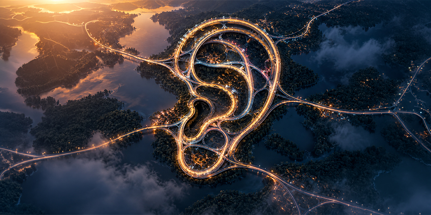 Aerial view of illuminated roads forming the shape of a human ear, symbolising employee listening and connected organisational insight.